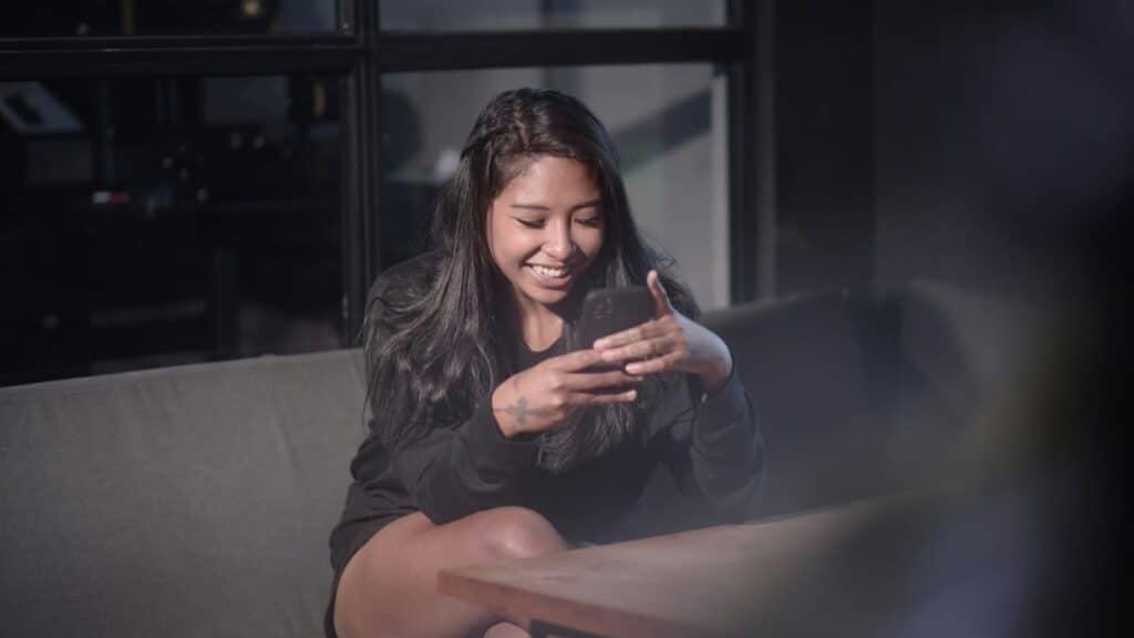 An image of a woman in Indonesia learning the language on a mobile app on her phone. 